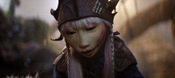 Movie still from “The Dark Crystal: Age of Resistance” (2019), created by Jim Henson – A person's face in a costume; Extreme Close Up shot, High angle