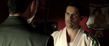 Movie still from “The Debt Collector” (2018), directed by Jesse V. Johnson – A man in a white shirt is talking to another man in a black suit; Close Up shot, Over the shoulder angle