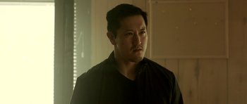 Movie still from “The Debt Collector” (2018), directed by Jesse V. Johnson – A person wearing a black shirt; Close Up shot, Low angle