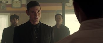 Movie still from “The Debt Collector” (2018), directed by Jesse V. Johnson – A man in a black suit standing in front of a mirror; Close Up shot, Over the shoulder angle