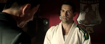 Movie still from “The Debt Collector” (2018), directed by Jesse V. Johnson – A man in a white uniform is looking at a man in a white uniform; Close Up shot, Over the shoulder angle