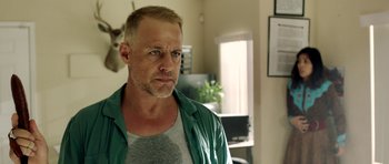 Movie still from “The Debt Collector” (2018), directed by Jesse V. Johnson – A person wearing a green shirt; Close Up shot, Over the shoulder angle