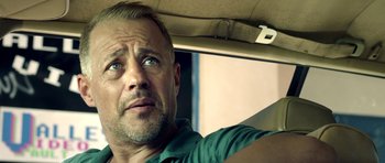 Movie still from “The Debt Collector” (2018), directed by Jesse V. Johnson – A person driving a car; Close Up shot, Over the shoulder angle