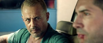 Movie still from “The Debt Collector” (2018), directed by Jesse V. Johnson – A person sitting in a car; Close Up shot, Over the shoulder angle