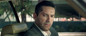 Movie still from “The Debt Collector” (2018), directed by Jesse V. Johnson – A person wearing a suit and tie; Close Up shot, Over the shoulder angle