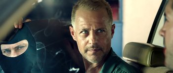 Movie still from “The Debt Collector” (2018), directed by Jesse V. Johnson – A person with a beard; Close Up shot, Low angle