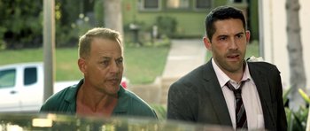 Movie still from “The Debt Collector” (2018), directed by Jesse V. Johnson – A man and a man wearing a suit and tie; Medium shot, Over the shoulder angle