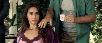 Movie still from “The Debt Collector” (2018), directed by Jesse V. Johnson – A woman sitting in front of a man holding a coffee cup; Close Up shot, Over the shoulder angle