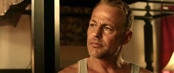 Movie still from “The Debt Collector” (2018), directed by Jesse V. Johnson – A person wearing a tank top; Close Up shot, Low angle