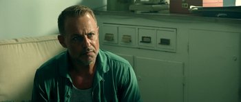 Movie still from “The Debt Collector” (2018), directed by Jesse V. Johnson – A person wearing a green shirt; Close Up shot, Over the shoulder angle