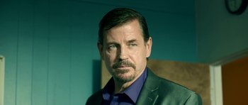 Movie still from “The Debt Collector” (2018), directed by Jesse V. Johnson – A person wearing a suit and tie; Close Up shot, Over the shoulder angle