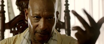 Movie still from “The Debt Collector” (2018), directed by Jesse V. Johnson – An older man is sitting in a wooden chair; Close Up shot, Low angle