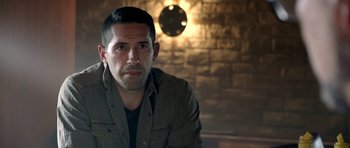 Movie still from “The Debt Collector” (2018), directed by Jesse V. Johnson – A person sitting in a room; Close Up shot, Over the shoulder angle