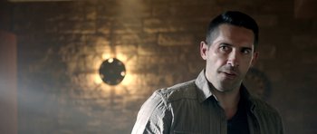 Movie still from “The Debt Collector” (2018), directed by Jesse V. Johnson – A person wearing a shirt; Close Up shot, Over the shoulder angle