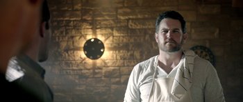 Movie still from “The Debt Collector” (2018), directed by Jesse V. Johnson – A man wearing an apron standing in front of a brick wall; Close Up shot, Low angle