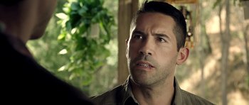 Movie still from “The Debt Collector” (2018), directed by Jesse V. Johnson – A person looking at the camera; Close Up shot, Over the shoulder angle