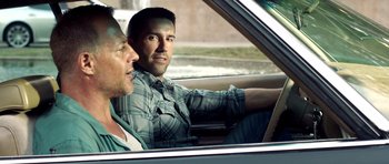 Movie still from “The Debt Collector” (2018), directed by Jesse V. Johnson – Two men sitting in the drivers seat of a car; Medium shot, Over the shoulder angle