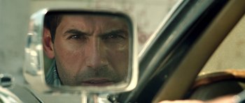 Movie still from “The Debt Collector” (2018), directed by Jesse V. Johnson – A person's face in a mirror; Extreme Close Up shot, Over the shoulder angle