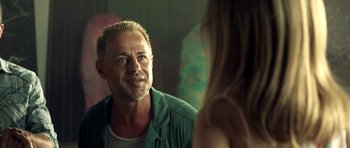 Movie still from “The Debt Collector” (2018), directed by Jesse V. Johnson – A man looking at a woman in a mirror; Close Up shot, Over the shoulder angle