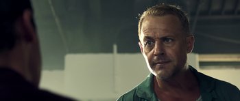 Movie still from “The Debt Collector” (2018), directed by Jesse V. Johnson – A person wearing a green shirt; Close Up shot, Over the shoulder angle