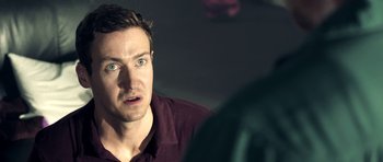 Movie still from “The Debt Collector” (2018), directed by Jesse V. Johnson – A person looking at the camera; Close Up shot, Over the shoulder angle