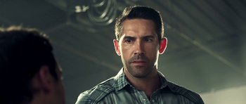 Movie still from “The Debt Collector” (2018), directed by Jesse V. Johnson – A person wearing a plaid shirt; Close Up shot, Over the shoulder angle