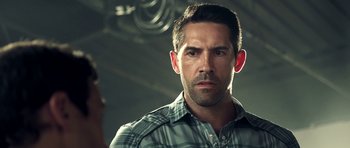 Movie still from “The Debt Collector” (2018), directed by Jesse V. Johnson – A person wearing a plaid shirt; Close Up shot, Over the shoulder angle