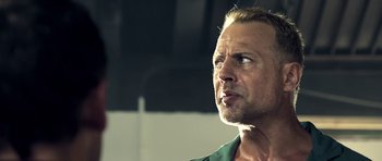 Movie still from “The Debt Collector” (2018), directed by Jesse V. Johnson – A person looking up at the sky; Close Up shot, Low angle