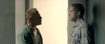 Movie still from “The Debt Collector” (2018), directed by Jesse V. Johnson – Two men standing next to each other in front of a wall; Close Up shot, Over the shoulder angle
