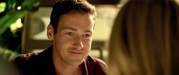 Movie still from “The Debt Collector” (2018), directed by Jesse V. Johnson – A person sitting in front of another person; Close Up shot, Over the shoulder angle