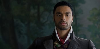 Movie still from “Bridgerton” (2020), created by Chris Van Dusen – A person wearing a suit and tie; Close Up shot, Low angle