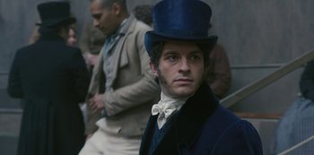 Movie still from “Bridgerton” (2020), created by Chris Van Dusen – A man wearing a blue top hat and a white bow tie; Close Up shot, Over the shoulder angle
