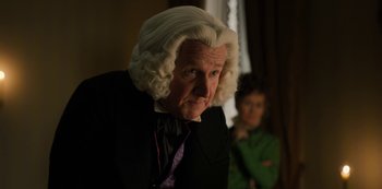 Movie still from “Bridgerton” (2020), created by Chris Van Dusen – An older man in a wig looking at the camera; Close Up shot, Over the shoulder angle