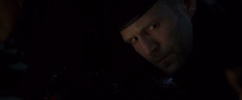 Movie still from “The Expendables” (2010), directed by Sylvester Stallone – A person wearing a hat looking at the camera; Close Up shot, Low angle