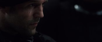 Movie still from “The Expendables” (2010), directed by Sylvester Stallone – A man's face in the dark; Extreme Close Up shot, Low angle