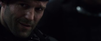 Movie still from “The Expendables” (2010), directed by Sylvester Stallone – A man's face in the dark; Close Up shot, Low angle