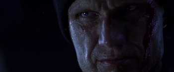 Movie still from “The Expendables” (2010), directed by Sylvester Stallone – A man's face with water droplets on his face; Extreme Close Up shot, Low angle