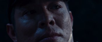 Movie still from “The Expendables” (2010), directed by Sylvester Stallone – A man's face in the dark; Extreme Close Up shot, Low angle
