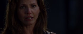 Movie still from “The Expendables” (2010), directed by Sylvester Stallone – A woman's face in the dark; Close Up shot, Over the shoulder angle