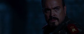 Movie still from “The Expendables” (2010), directed by Sylvester Stallone – A person with a beard; Close Up shot, Over the shoulder angle