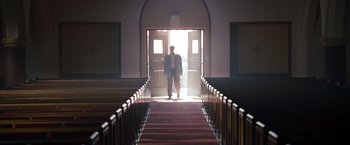 Movie still from “The Expendables” (2010), directed by Sylvester Stallone – A man standing at the top of a set of stairs; Wide shot, Low angle