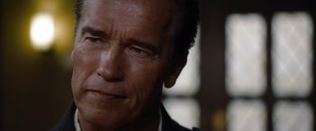 Movie still from “The Expendables” (2010), directed by Sylvester Stallone – A man's face in a dark room; Close Up shot, Over the shoulder angle