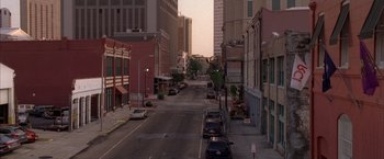 Movie still from “The Expendables” (2010), directed by Sylvester Stallone – An empty city street with cars parked on the side of the road; Extreme Wide shot, High angle