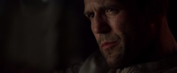 Movie still from “The Expendables” (2010), directed by Sylvester Stallone – A man's face in the dark; Close Up shot, Low angle