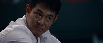 Movie still from “The Expendables” (2010), directed by Sylvester Stallone – A person wearing a white shirt; Close Up shot, Over the shoulder angle