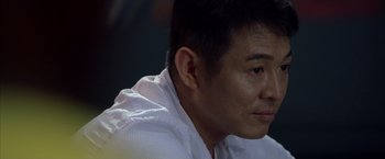 Movie still from “The Expendables” (2010), directed by Sylvester Stallone – A person wearing a white shirt; Close Up shot, Over the shoulder angle