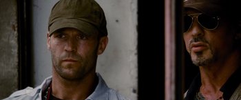 Movie still from “The Expendables” (2010), directed by Sylvester Stallone – A person wearing a hat; Close Up shot, Low angle