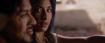 Movie still from “The Expendables” (2010), directed by Sylvester Stallone – A woman's face as she looks out a window; Close Up shot, Over the shoulder angle