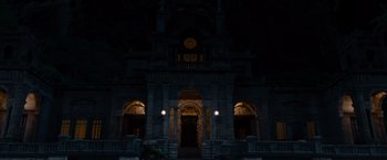 Movie still from “The Expendables” (2010), directed by Sylvester Stallone – A building with a clock on the front of it; Extreme Wide shot, Low angle