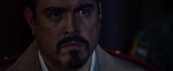 Movie still from “The Expendables” (2010), directed by Sylvester Stallone – A person with a beard and mustache; Close Up shot, Over the shoulder angle